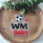 Preview: Plotterdatei Fußball WM Baby entgittert und zusammen gelegt auf einem Holzteller